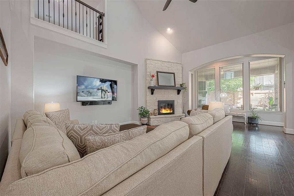 Large living room with gas fireplace and separate sitting area overlooking the patio.  Option to leave all furniture seen pictured (not including TV).