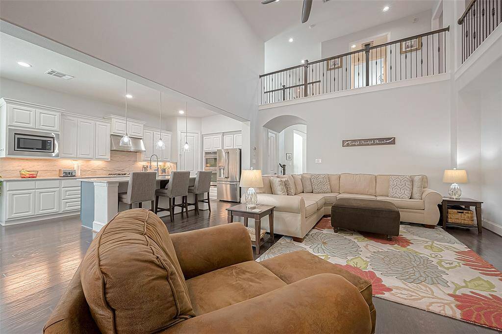 Another view of large living room and kitchen.  Kitchen includes gas stove, double ovens, and incredibly large walk-in pantry.  Refrigerator stays.  Brand new large living room fan provides plenty of air flow during those warm summer months.