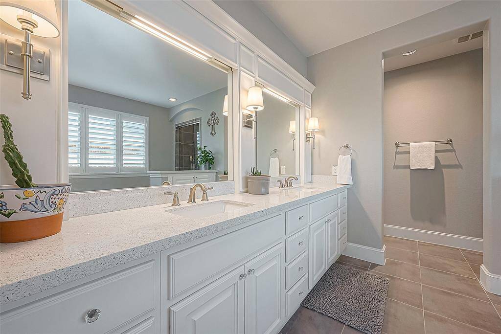 Large master bathroom with custom built-ins and lighting.  Large garden tub and walk-in shower.