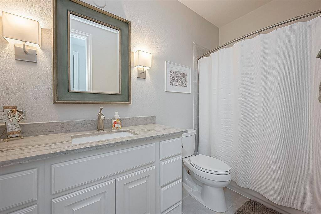 Downstairs guest bath with custom lighting and beautiful vanity mirror.