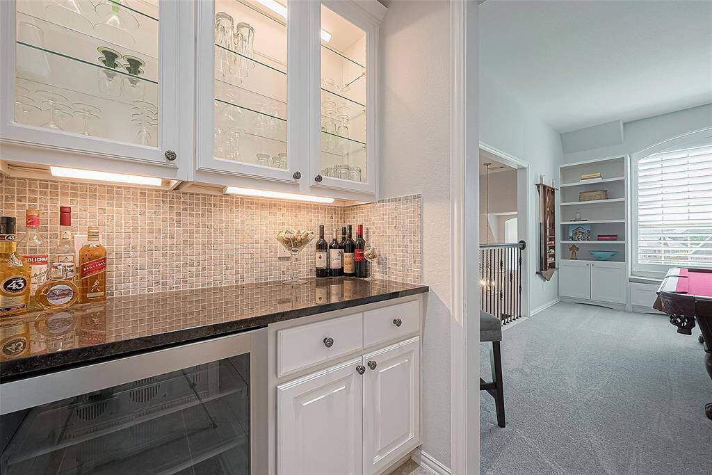 Upstairs bar area next to game room, across from half bath.  Includes stainless steel wine fridge.