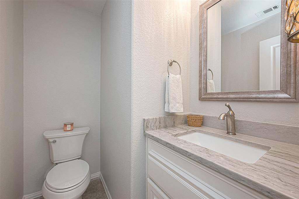 Upstairs half bath across from bar area.  Located just off walkway overlooking living room.