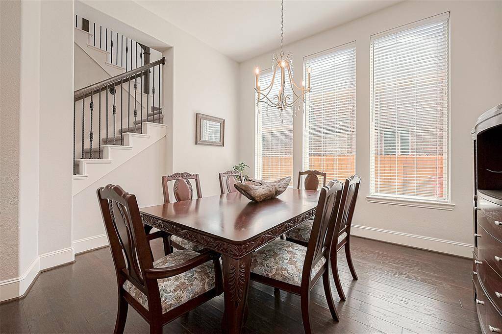 Formal dining room with tall ceilings and beautiful lighting.  Option to leave all furniture seen pictured (including additional table leaf and 2 additional chairs to accommodate seating for 8).