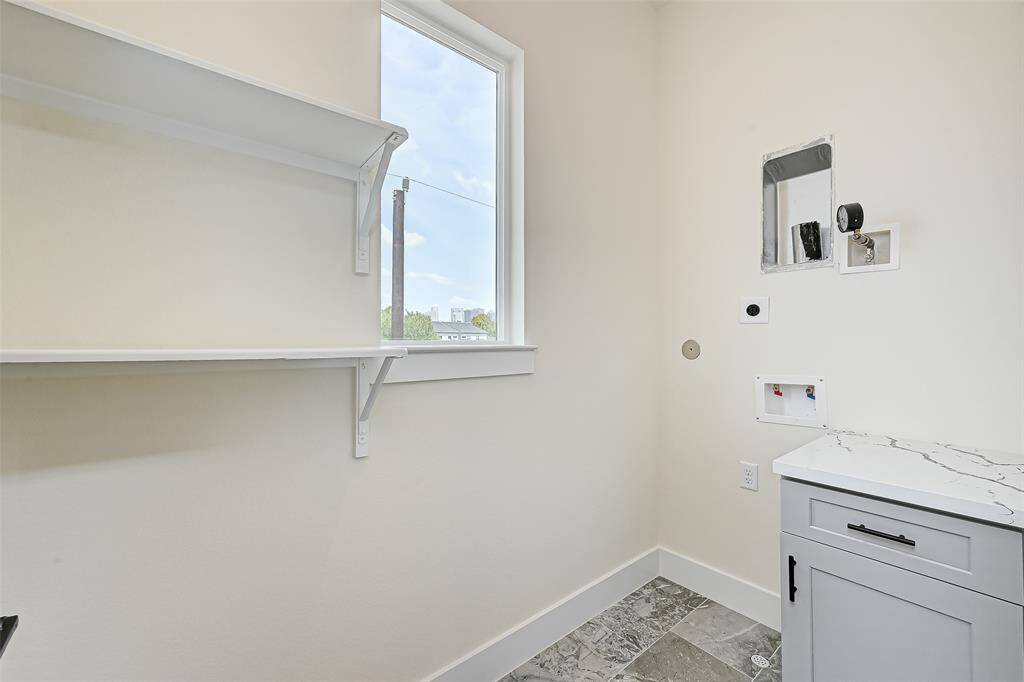 Stackable laundry room with extra storage cabinet.