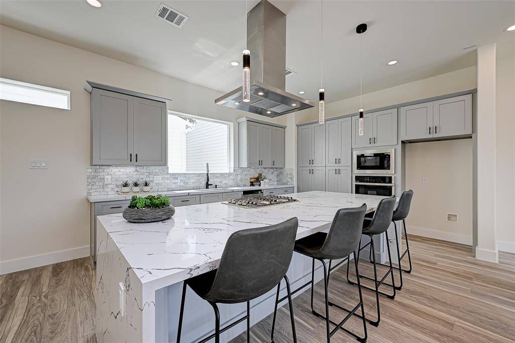 Waterfall quartz countertop island.(Previously staged.)(Previously staged.)