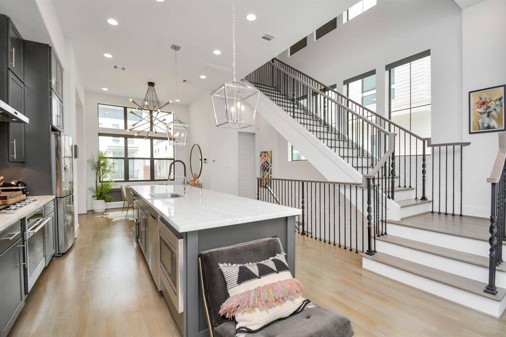 Natural light pours in through the expansive staircase windows, creating a bright and inviting atmosphere.