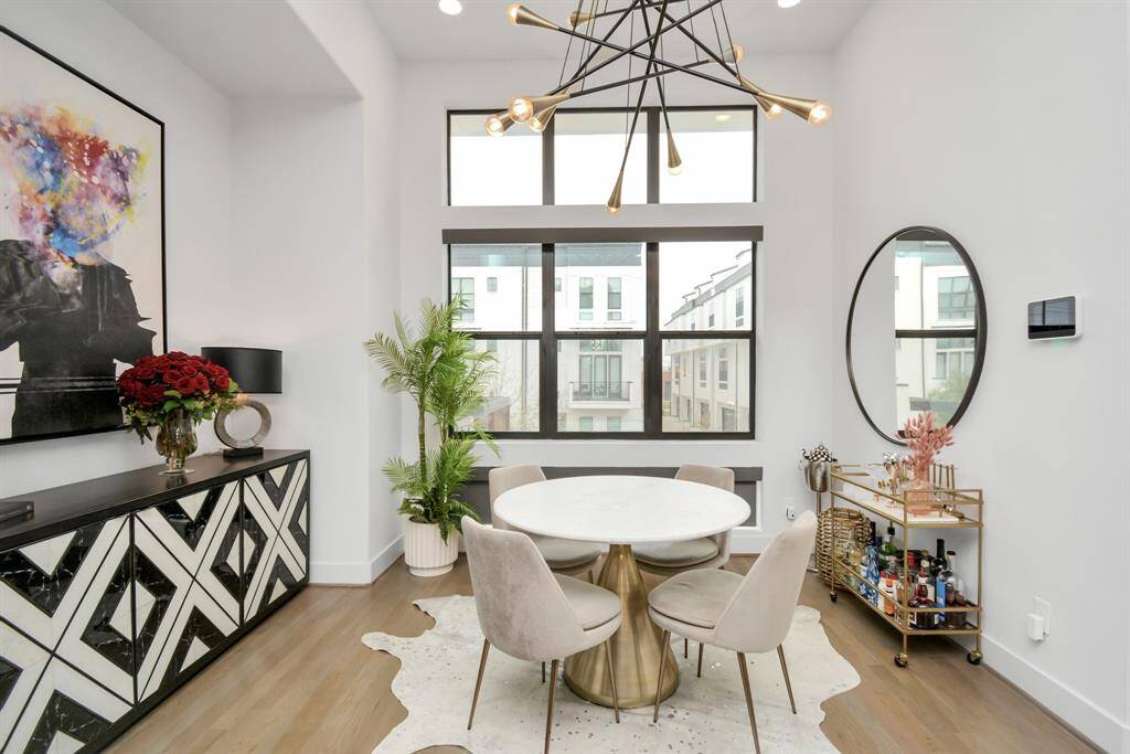 Bright dining area featuring expansive windows with convenient electronic blinds.  ((dining light fixture will be removed)