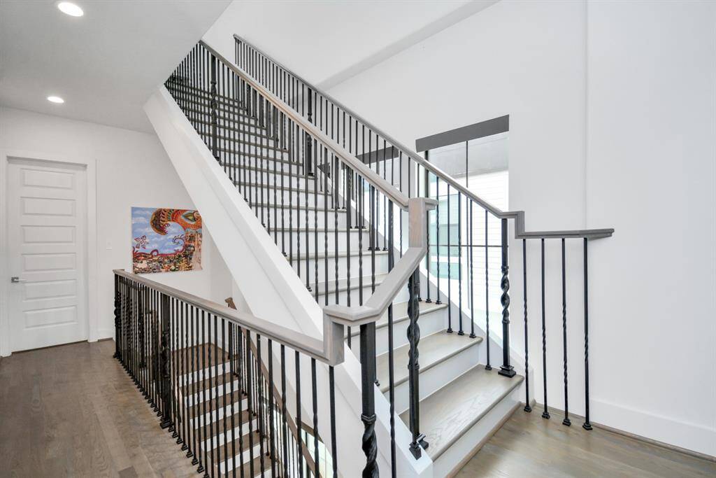 Welcome to the third-floor landing, leading to a stylish secondary bedroom.