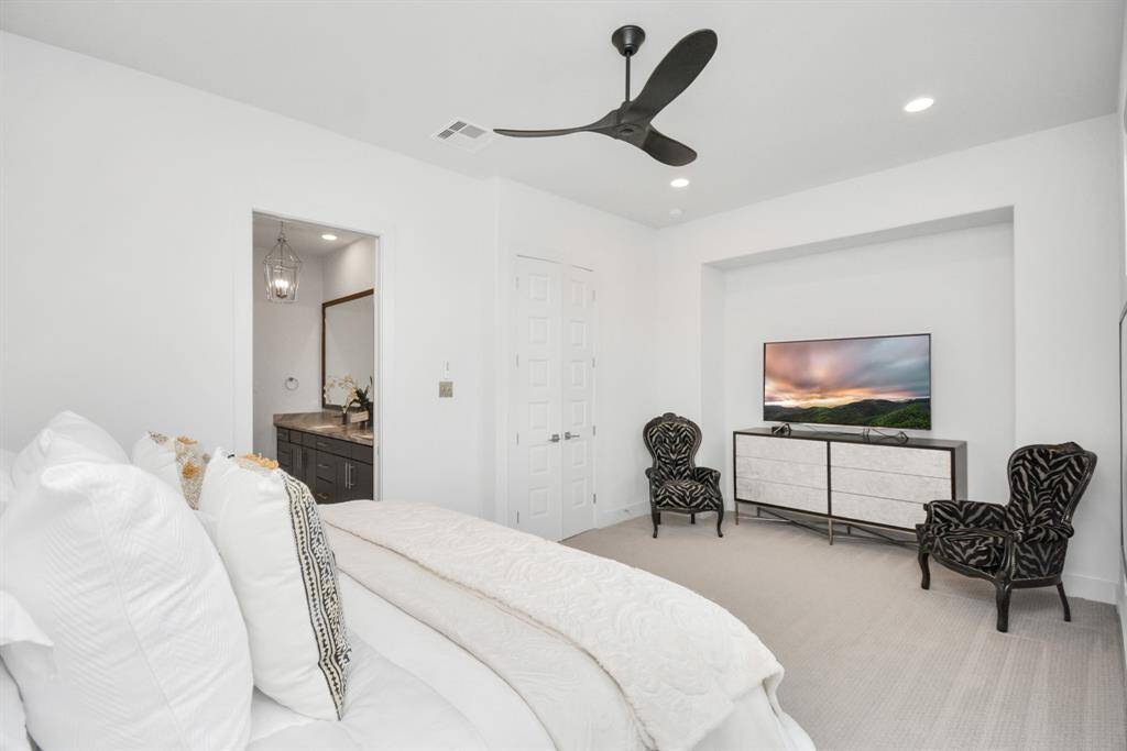 Expansive primary bedroom SUITE with elegant design and ample natural light, leads into the primary bathroom and closet.