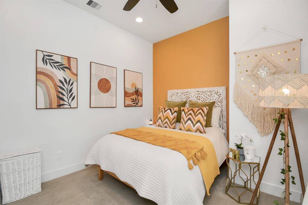 The stylish third-floor bedroom features vibrant accents.