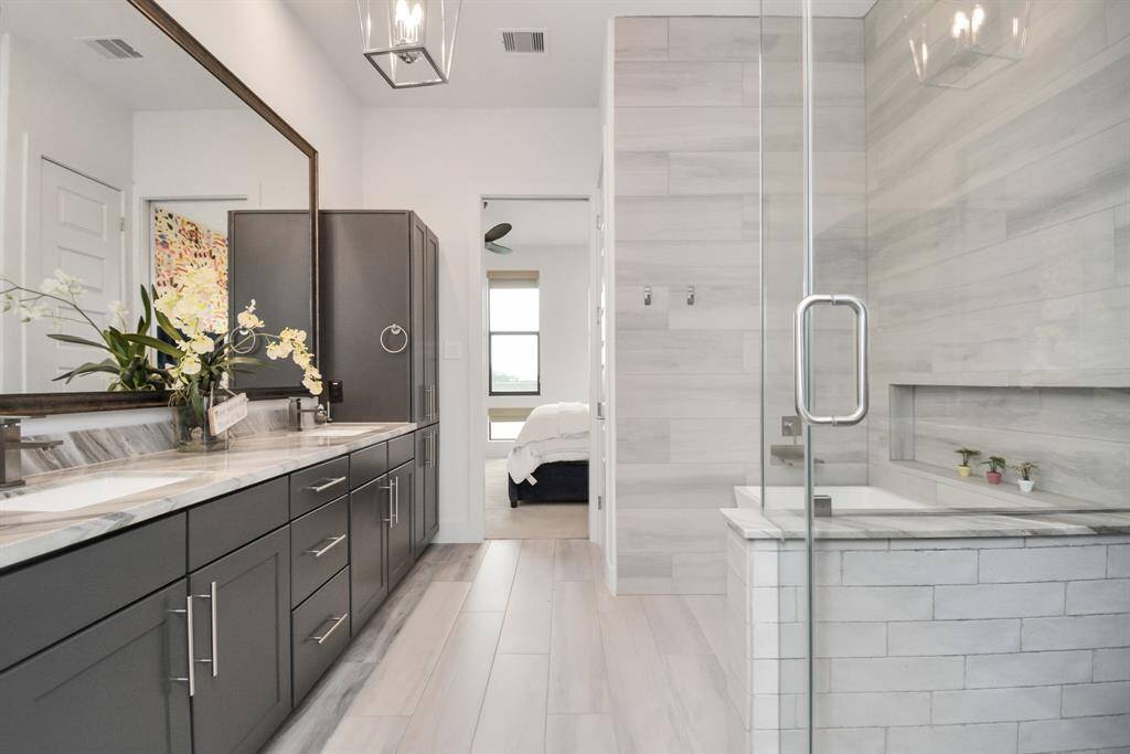 Experience luxury in this third-floor primary bathroom, complete with dual sinks, a separate tub, and a spacious shower.