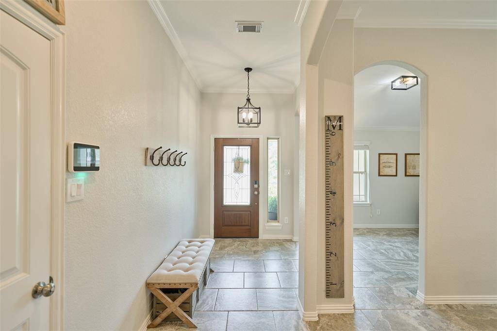 A peek back at that pretty front door as we head down the hall .