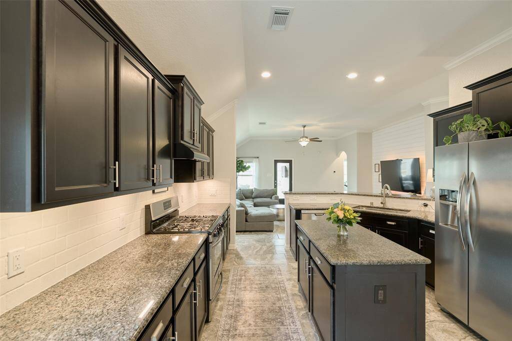 A chef's dream kitchen with lots of counter space, an island all overlooking the family room!