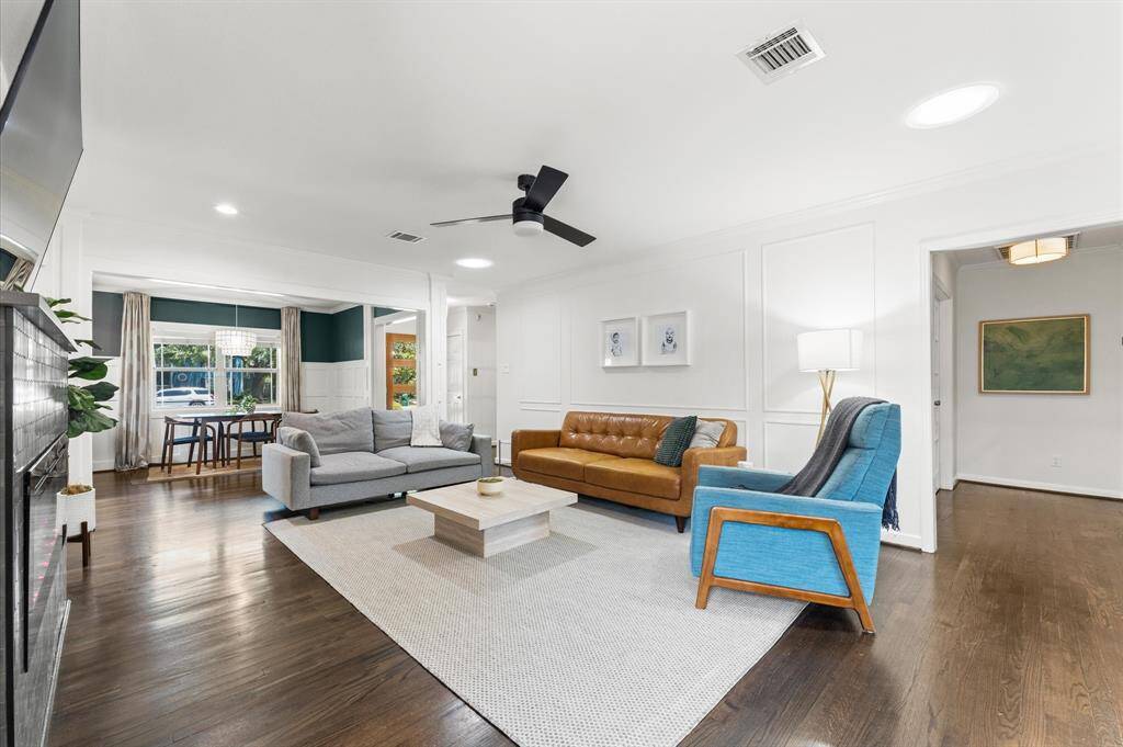 large family room. Photo shows the hallway to the primary retreat.