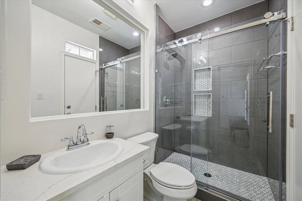 LOVE THIS BATHROOM WITH CUSTOM SHOWER, FRAMELESS SLIDING GLASS DOOR, AND GRANITE COUNTERS.