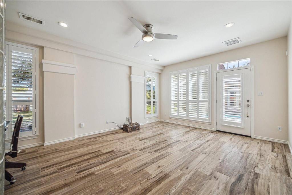 GRAND PRIMARY SUITE FEATURES WOOD SHUTTERS AND ACCESS TO THE BACKYARD AND POOL.