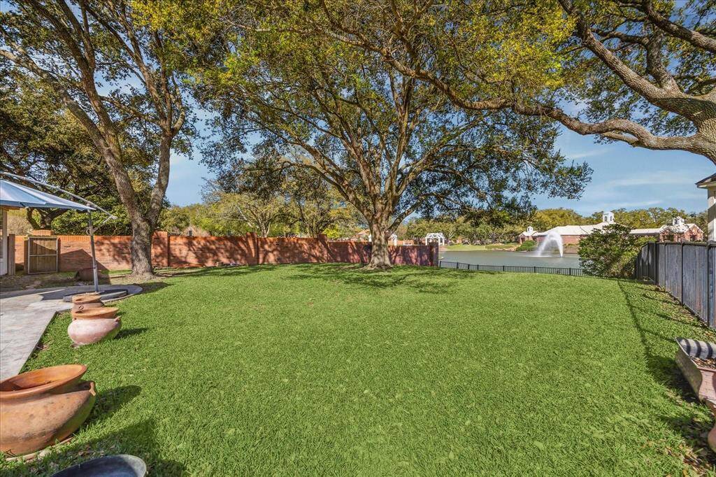 MASSIVE BACKYARD LEADS TO THE LAKE AND ENJOYS MATURE TREES