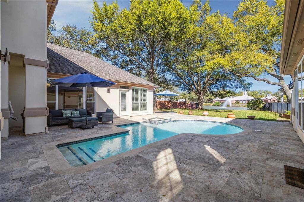 DIVE INTO SUMMER FUN! THE POOL AND SURROUNDING PATIO IS IDEAL FOR OUTDOOR ENTERTAINING AND ENSURE PRIVACY.
