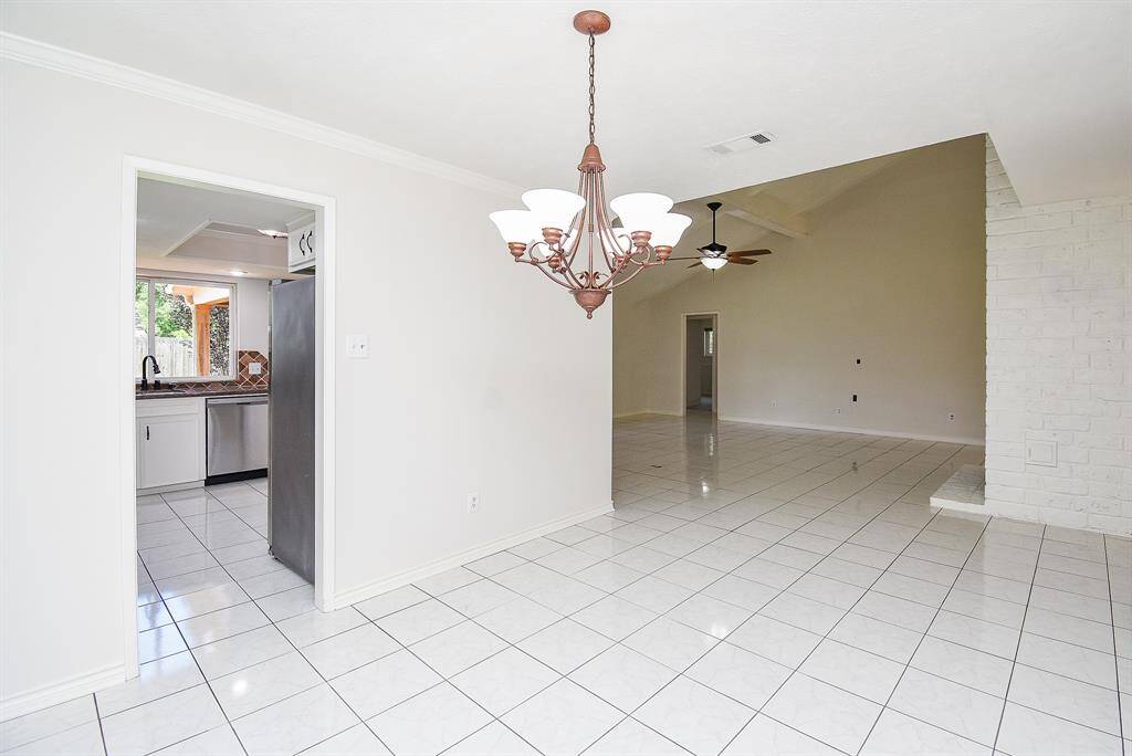 View from formal dining into kitchen on the left and family/living room on right