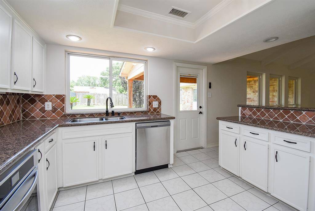 All kitchens need that large window don't they?   Overlooking backyard almost makes doing dishes fun ;)