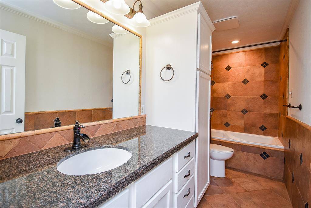 Bath 2 with granite counter and great cabinet and storage space