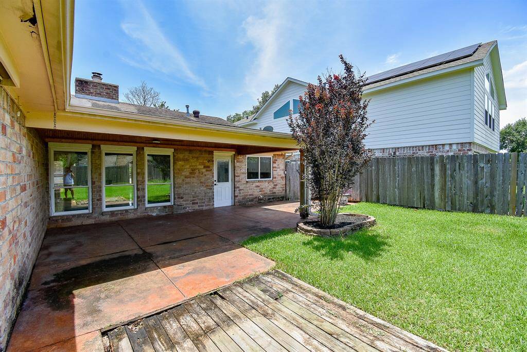 Extended view of covered patio with spot for your BBQ.
