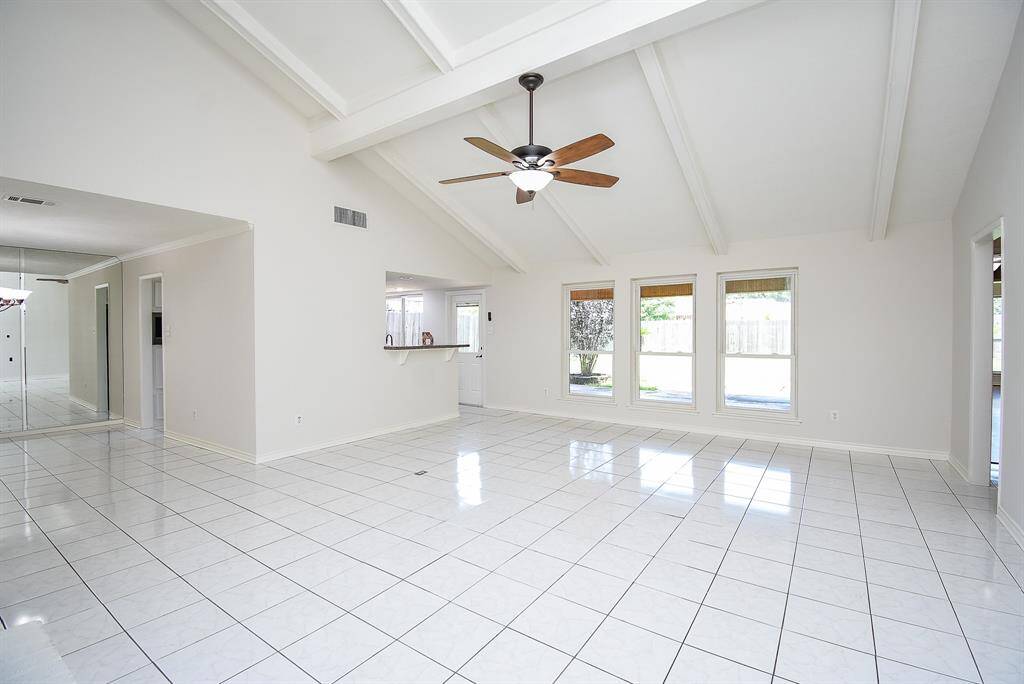 Freshly painted, the natural light flows into family room with Tile flooring throughout all living areas.  Don't you love those beams!
