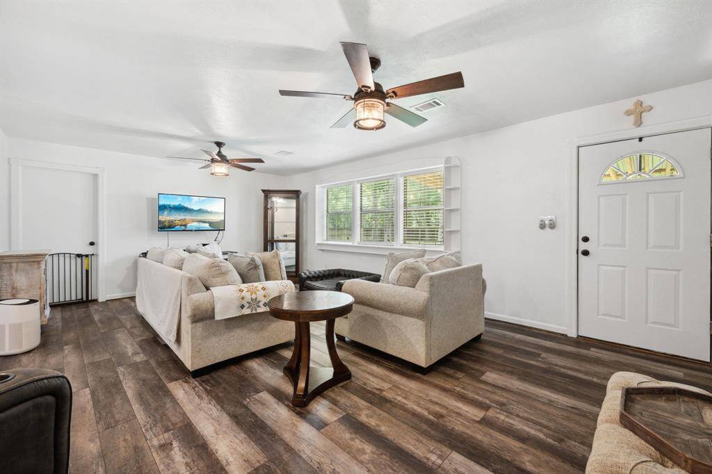 Light colors, vinyl flooring, picture style windows.