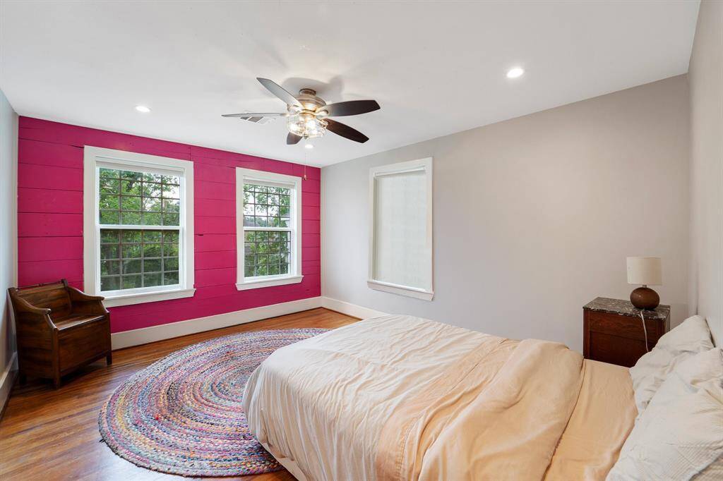 This charming bedroom offers rich hardwood floors, a ceiling fan for year-round comfort, and convenient access to a shared Jack and Jill bathroom—perfect for connected living.