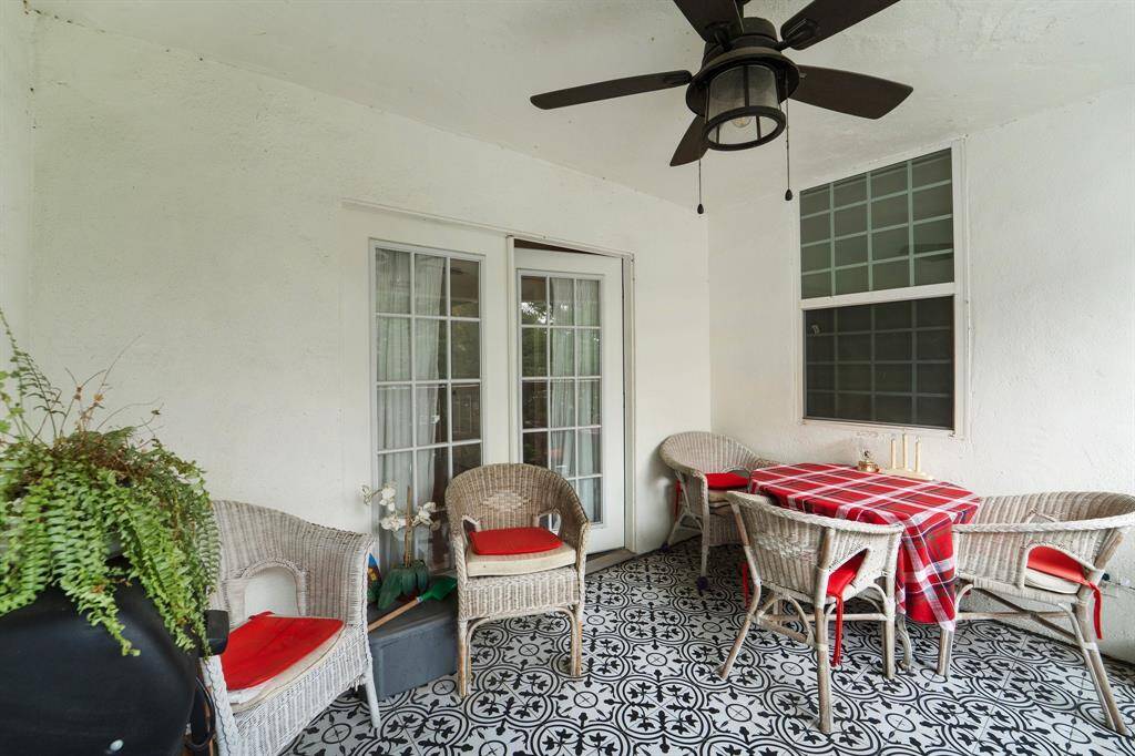 Located off the hallway, this charming balcony offers a perfect spot to unwind with its tile flooring, ceiling fan, and inviting atmosphere.