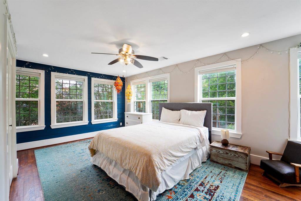 This charming bedroom offers rich hardwood floors, a ceiling fan for year-round comfort, and convenient access to a shared Jack and Jill bathroom—perfect for connected living.