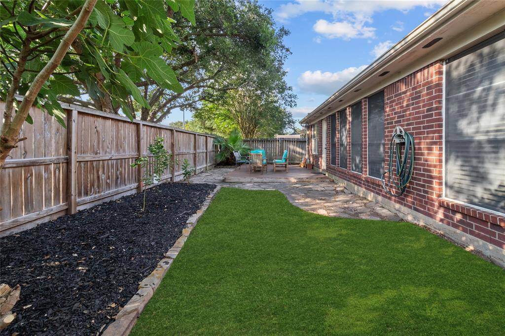 Enjoy the outdoors in this beautiful backyard, complete with a wood deck, full fencing, and plenty of space for relaxing or entertaining.