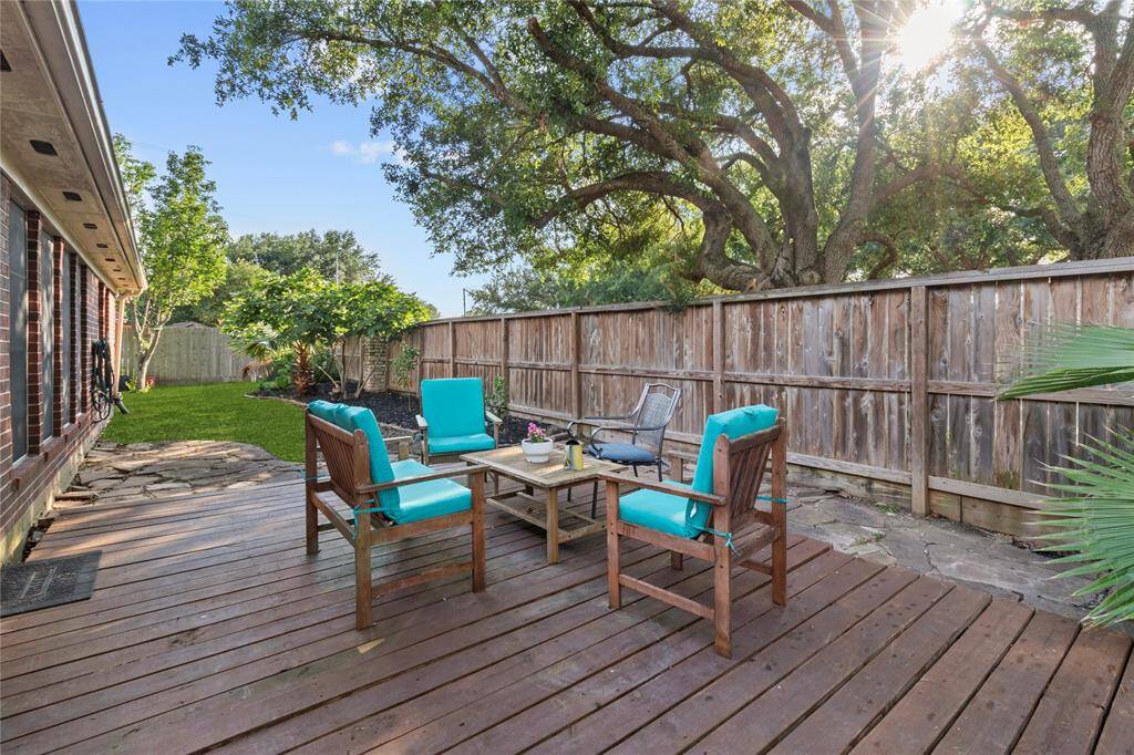Unwind or entertain with ease in this backyard retreat—featuring a spacious wood deck that’s ideal for creating your own cozy outdoor sitting area.