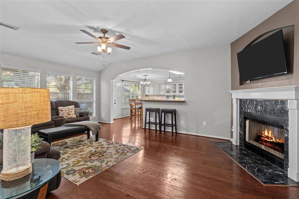 As you move through the home, you’re welcomed into the open family room where the beautiful double-sided fireplace becomes a standout feature—adding warmth and charm to the heart of the home.