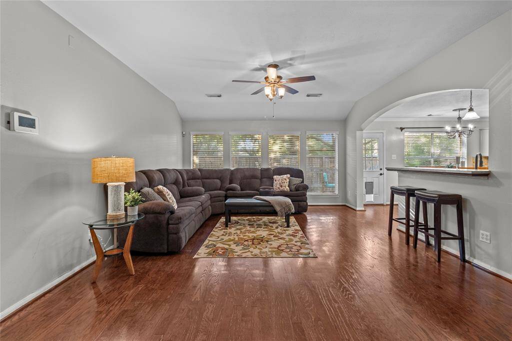 This spacious family room is made for gathering—plenty of room for everyone to relax, with natural light pouring in through the back wall of windows and space to comfortably fit a large sectional.