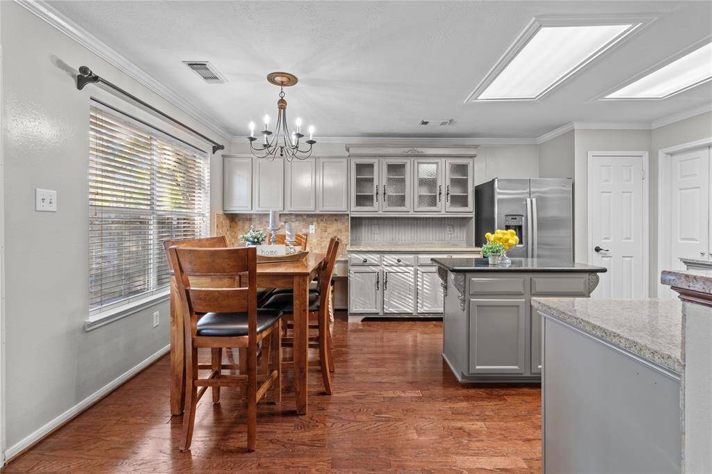 Gather around the kitchen table with a view—this open, light-filled space connects seamlessly to the kitchen, making it ideal for both casual meals and entertaining.