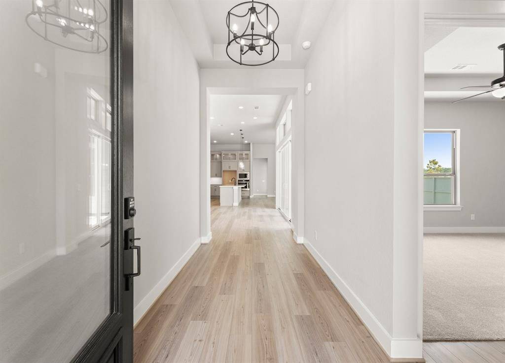 The Entry Reveals a 12ft. Ceiling and Luxury Vinyl Plank Flooring