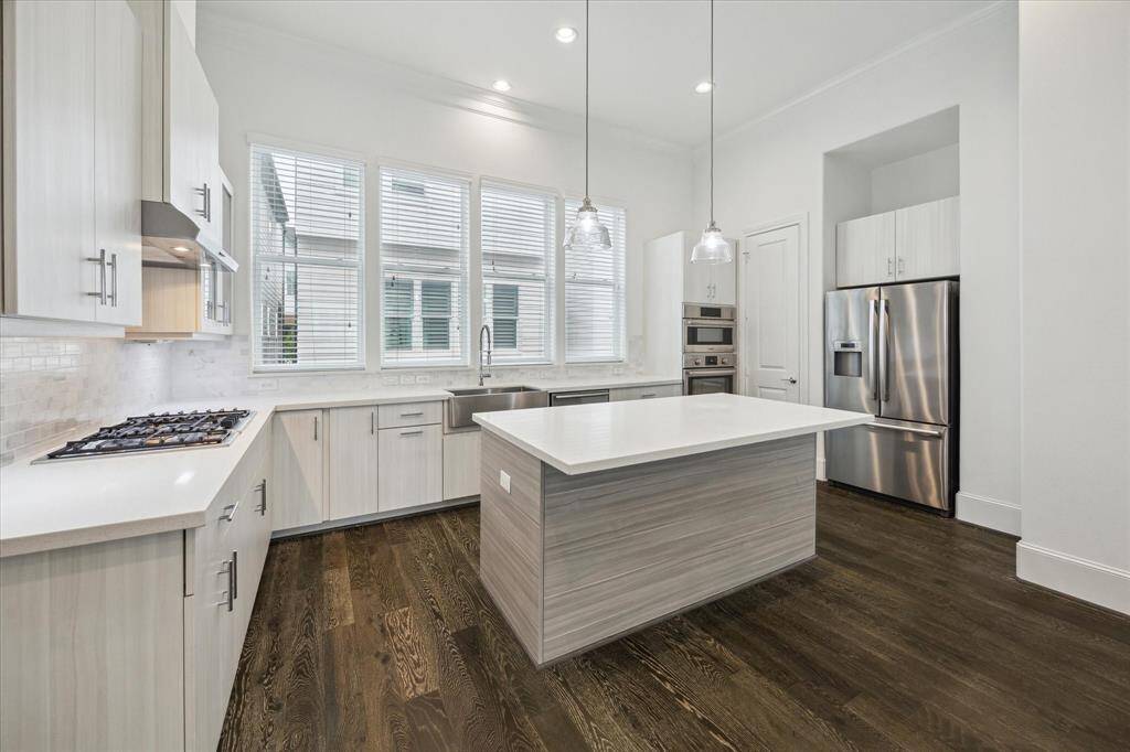 Gourmet kitchen includes stainless steel Bosch appliances, quartz countertops
