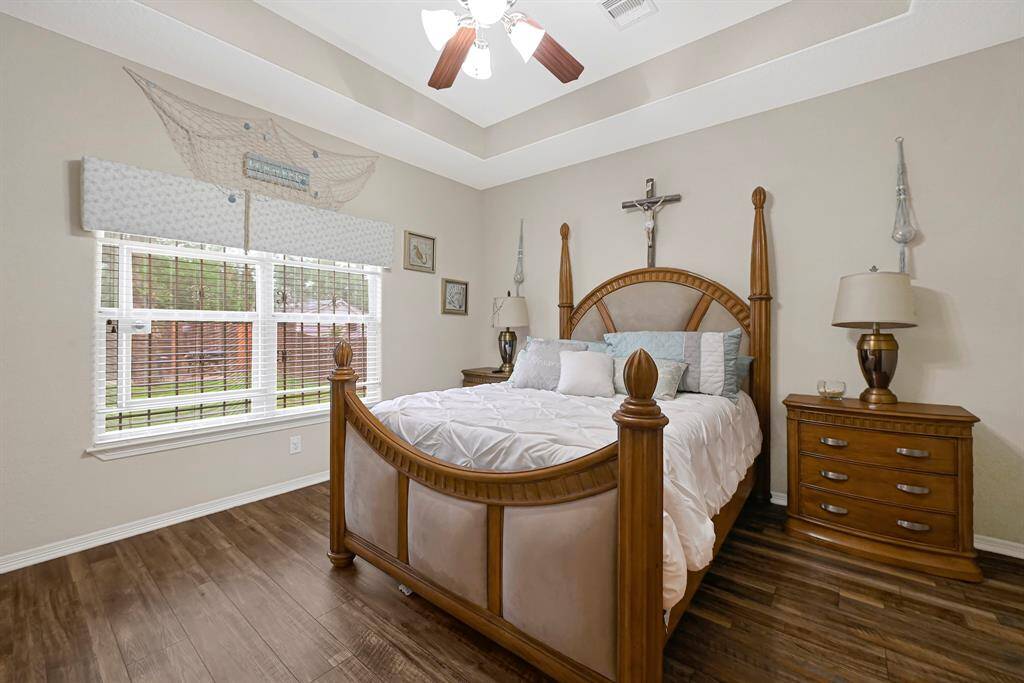 Tranquil primary suite with tray ceiling, and large windows that bring in abundant natural light creating the perfect retreat.