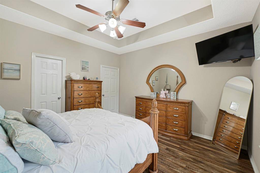 Tranquil primary suite with tray ceiling, and large windows that bring in abundant natural light creating the perfect retreat.
