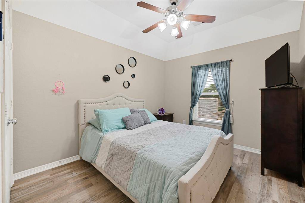 Bright and inviting upstairs bedroom ideal for family, guests, or a home office.