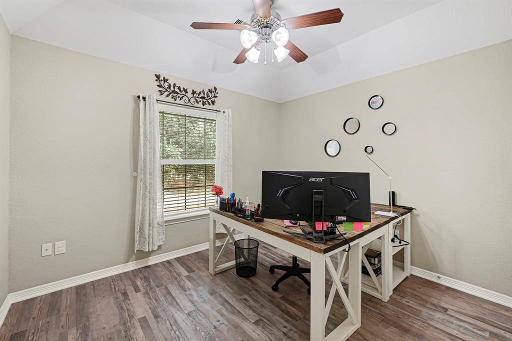 Upstairs bedroom with tray ceiling currently used as an office, but offers flexibility for guests, hobby, or additional living space.