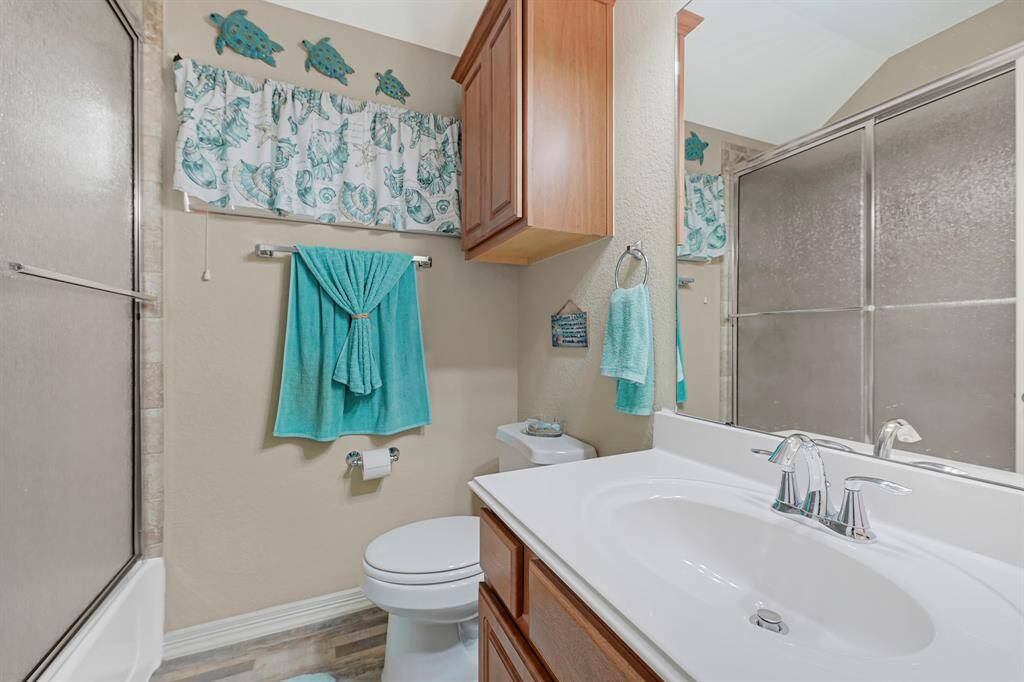 Upstairs full bath with tub/shower combo, built-in storage, convenient to secondary bedrooms.