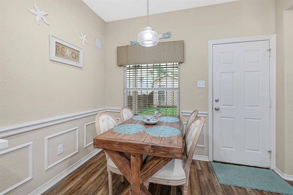 Charming breakfast nook with custom trim and backyard views perfect for casual dining or morning coffee.