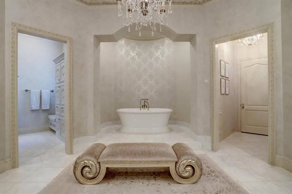 Immerse yourself in spa-like luxury and timeless elegance. Custom wall coverings, fixtures, and lighting elevate every detail, while the serene soaking tub offers ultimate relaxation.