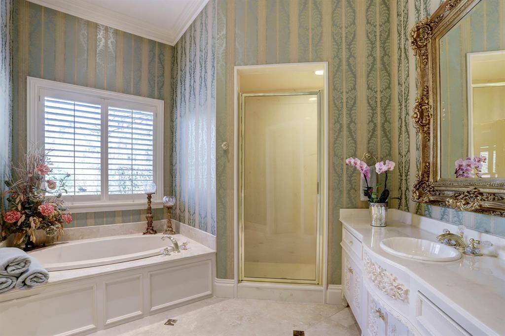 Private ensuite bath on the first floor, offering the potential for a secondary primary suite with its own entrance to the motor court.