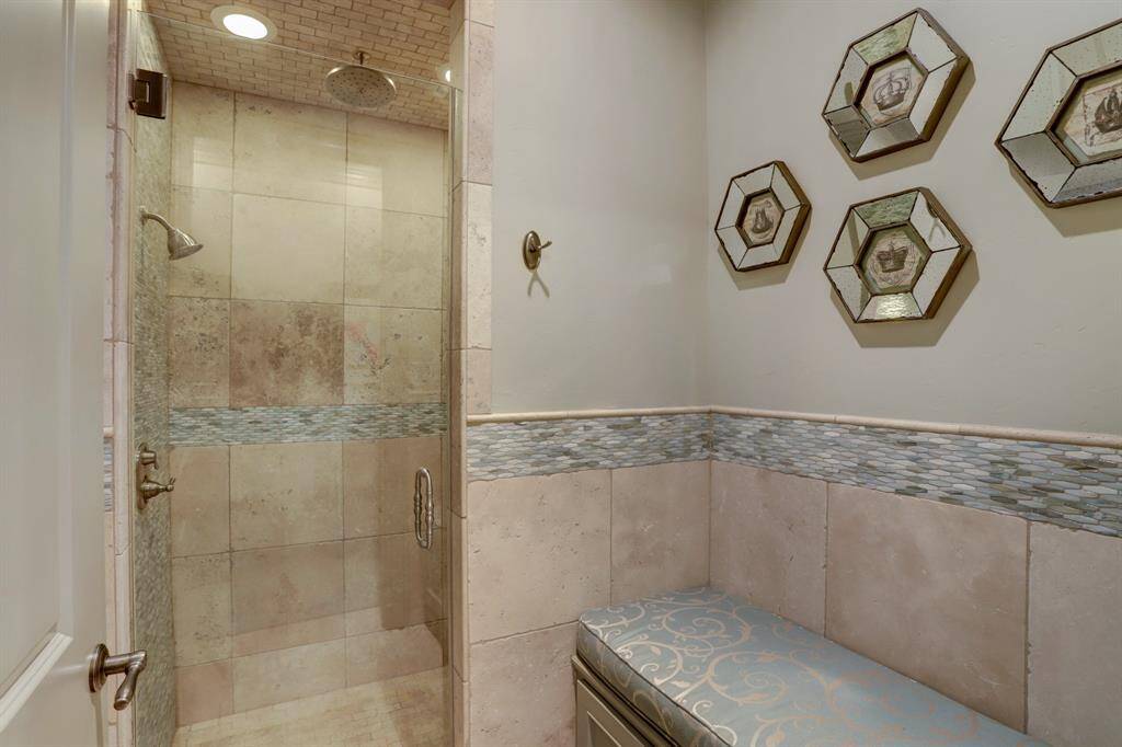 Guest bath in the pool house, complete with a spacious changing area for added convenience.