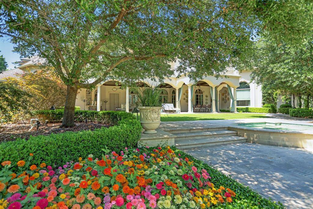 Enjoy extensive covered outdoor living on the first floor of the main house, plus a private balcony above, embraced by majestic live oak trees that provide year-round shade.