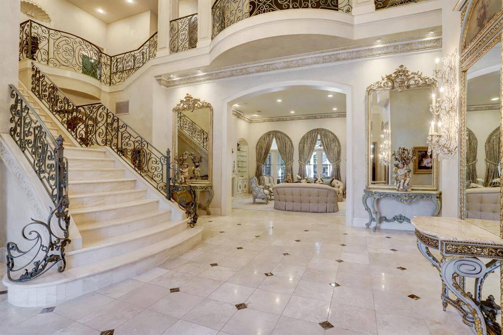 A seamless transitions into the formal living area, which incorporates luxurious materials, intricate detailing, and an overall sense of grandeur.
