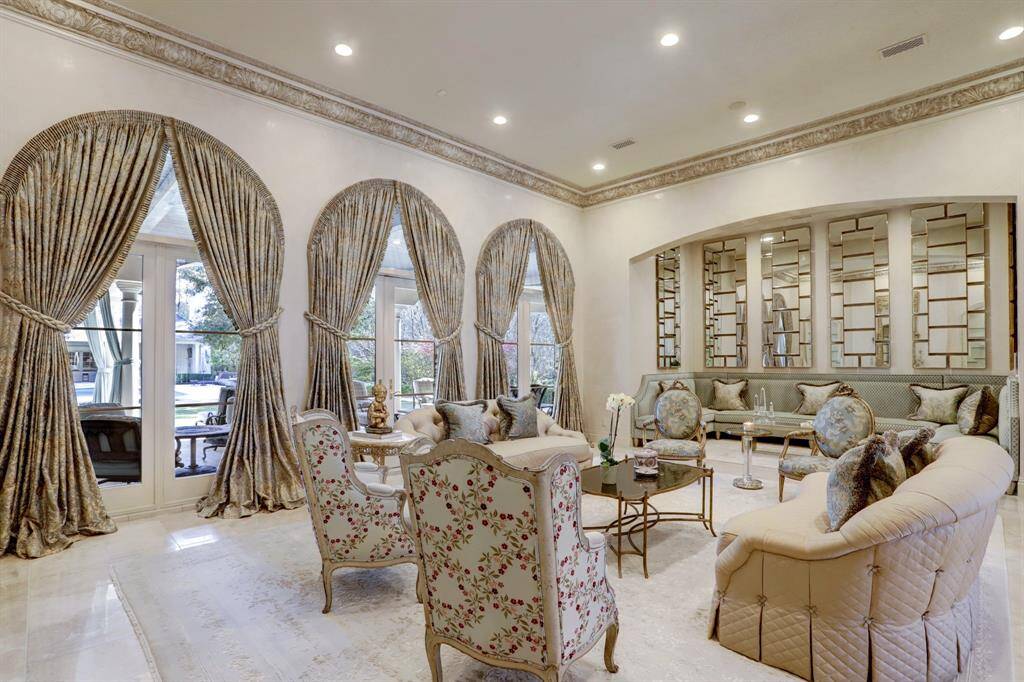 Formal living room stuns at every angle. Walls of windows and doors to outdoor living while also adding natural light filling the space.